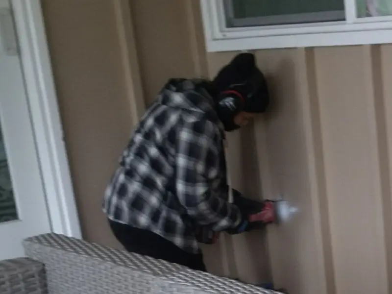 Professional electrician installing an exterior outlet in San Manuel